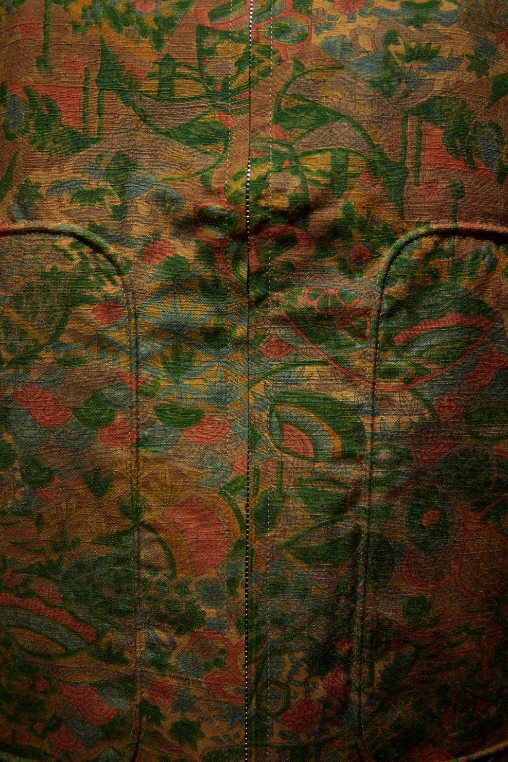 Close-up of a woven fabric with green floral patterns